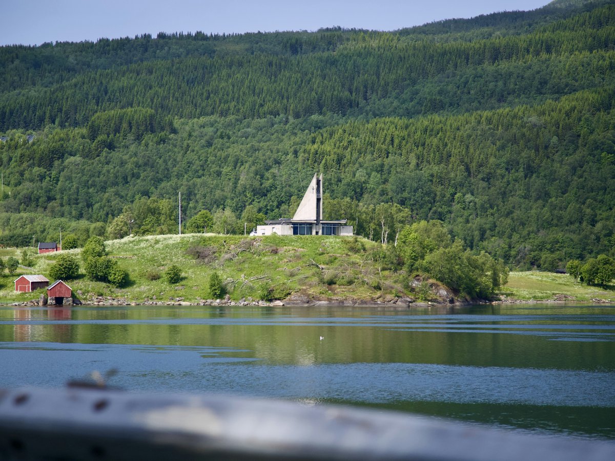 a house on a hill overlooking a body of water