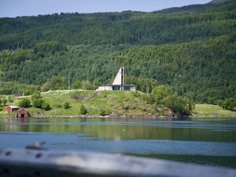 a house on a hill overlooking a body of water