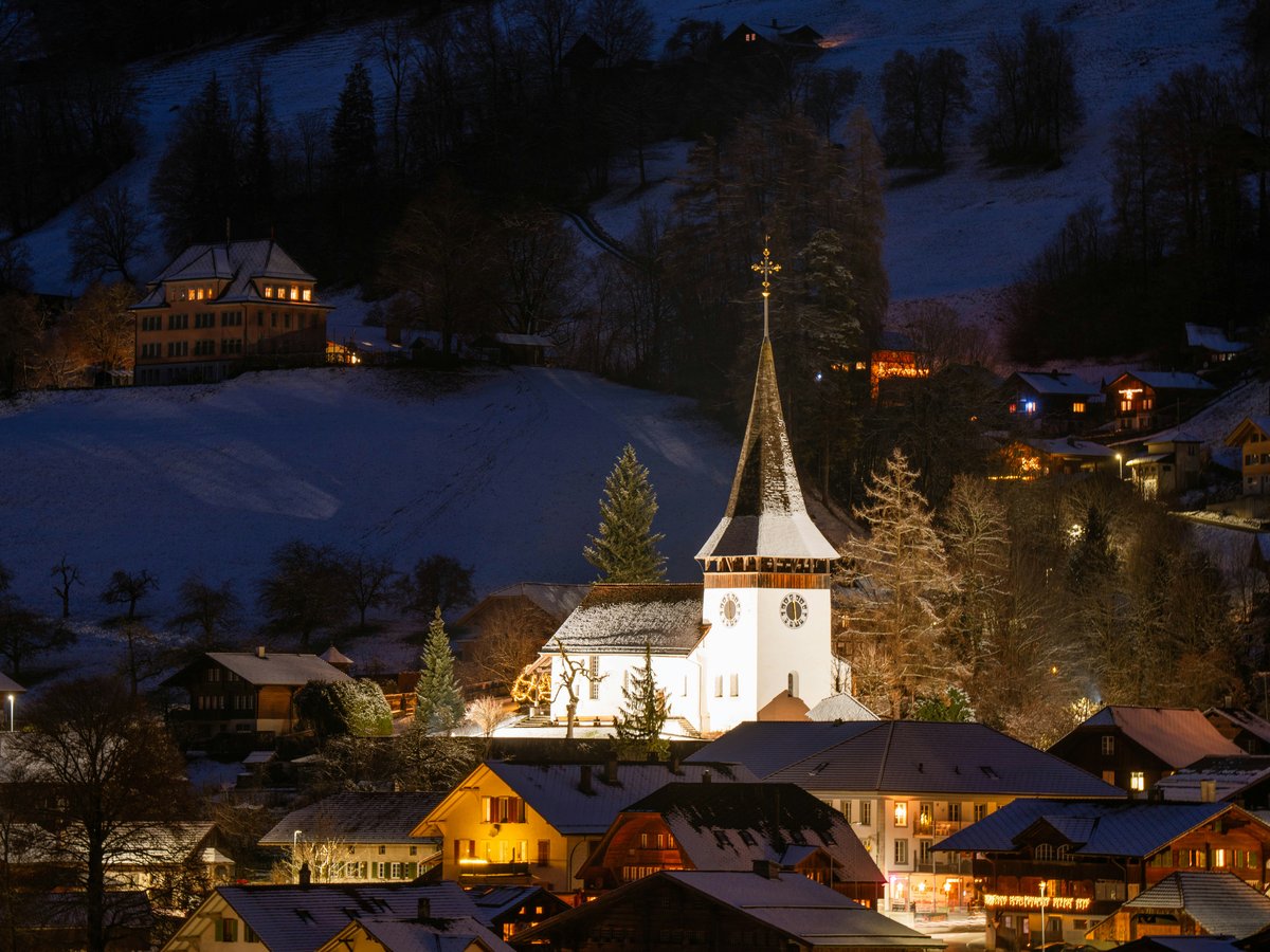 A town with a church lit up at night