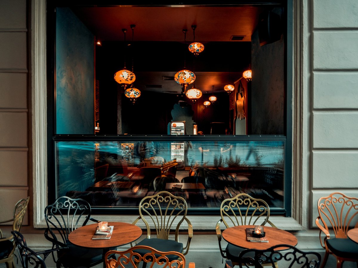 brown outdoor cafe tables and chairs