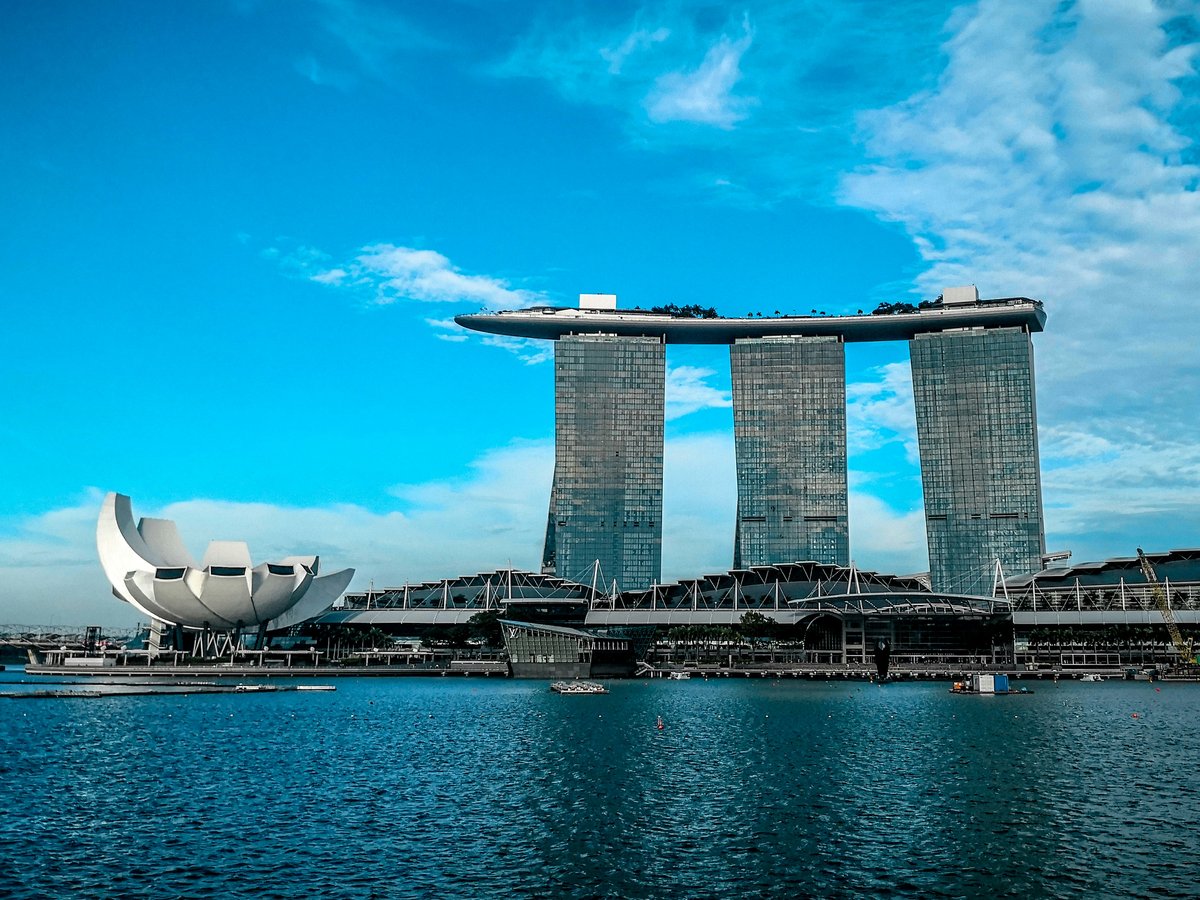 gray concrete buildings near body of water