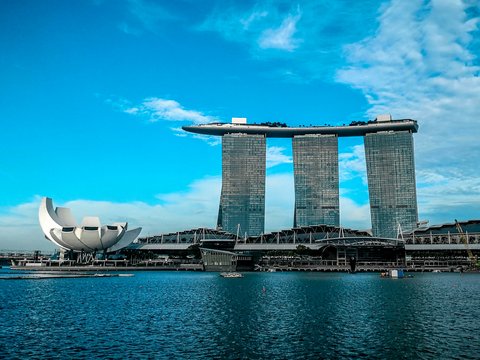 gray concrete buildings near body of water