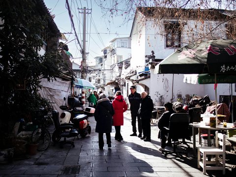 A group of people walking down a street