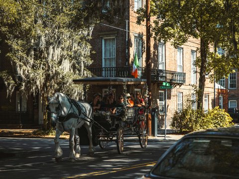 a horse carriage with people in it