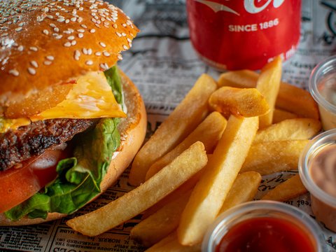 a hamburger and french fries with ketchup and a drink