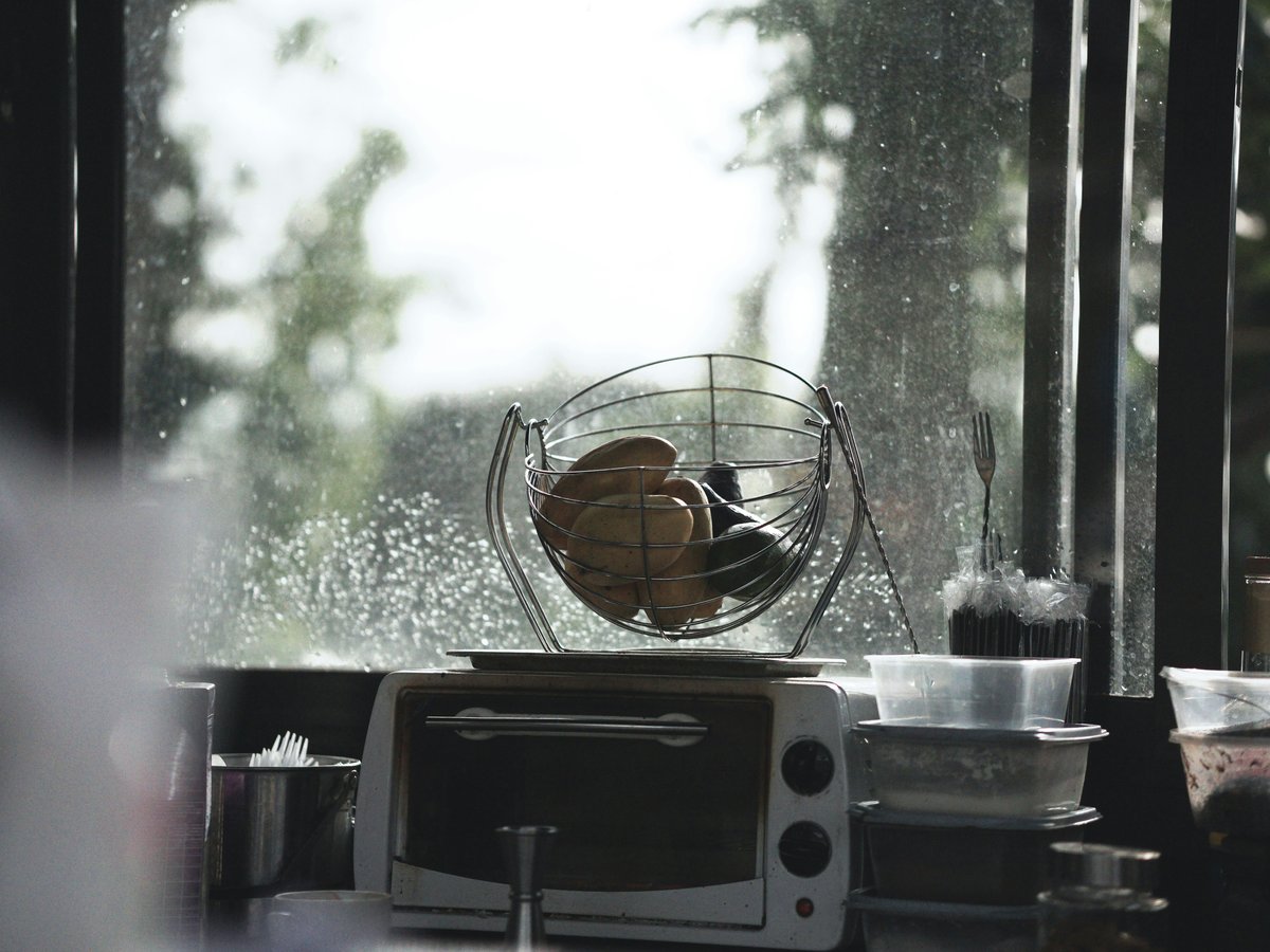a toaster oven sitting on top of a counter next to a window