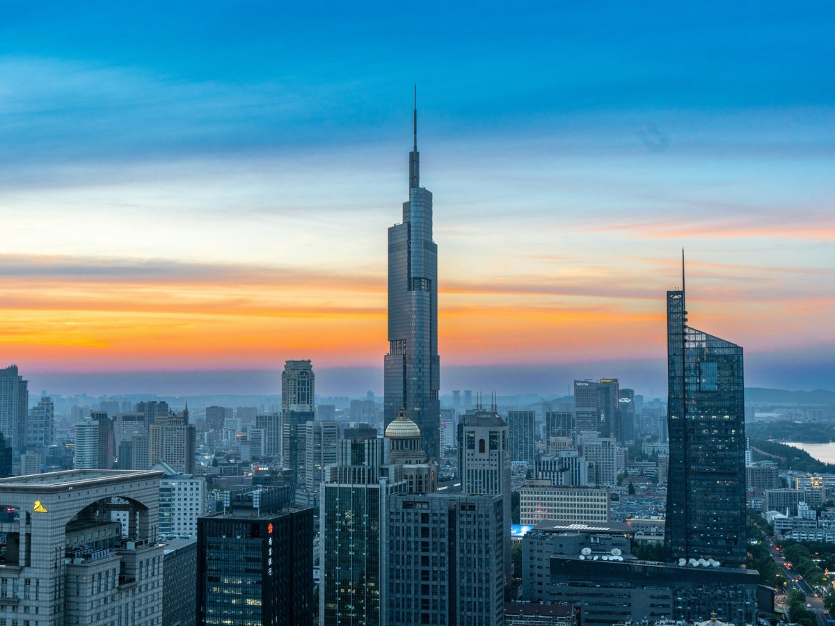 A view of a city at sunset from the top of a building