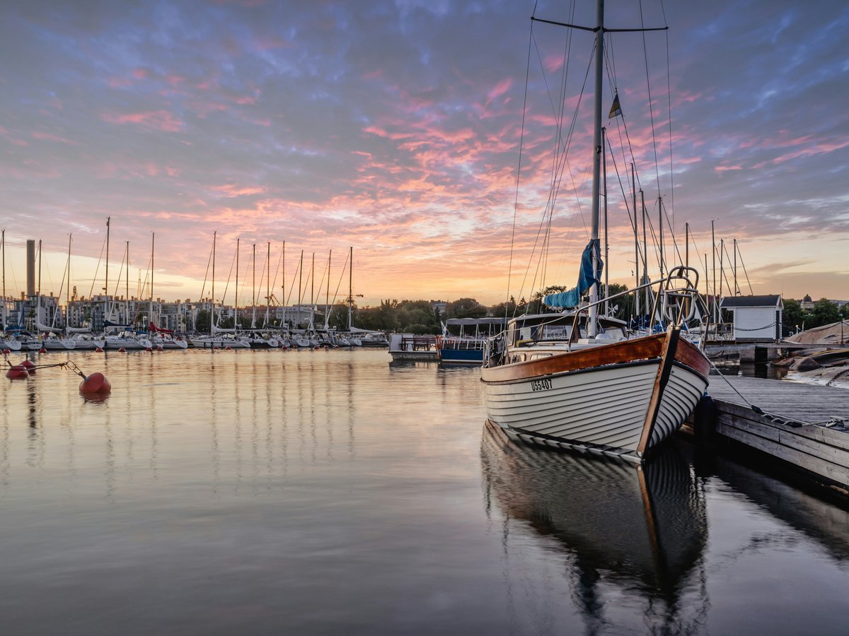a group of boats sit in a harbor