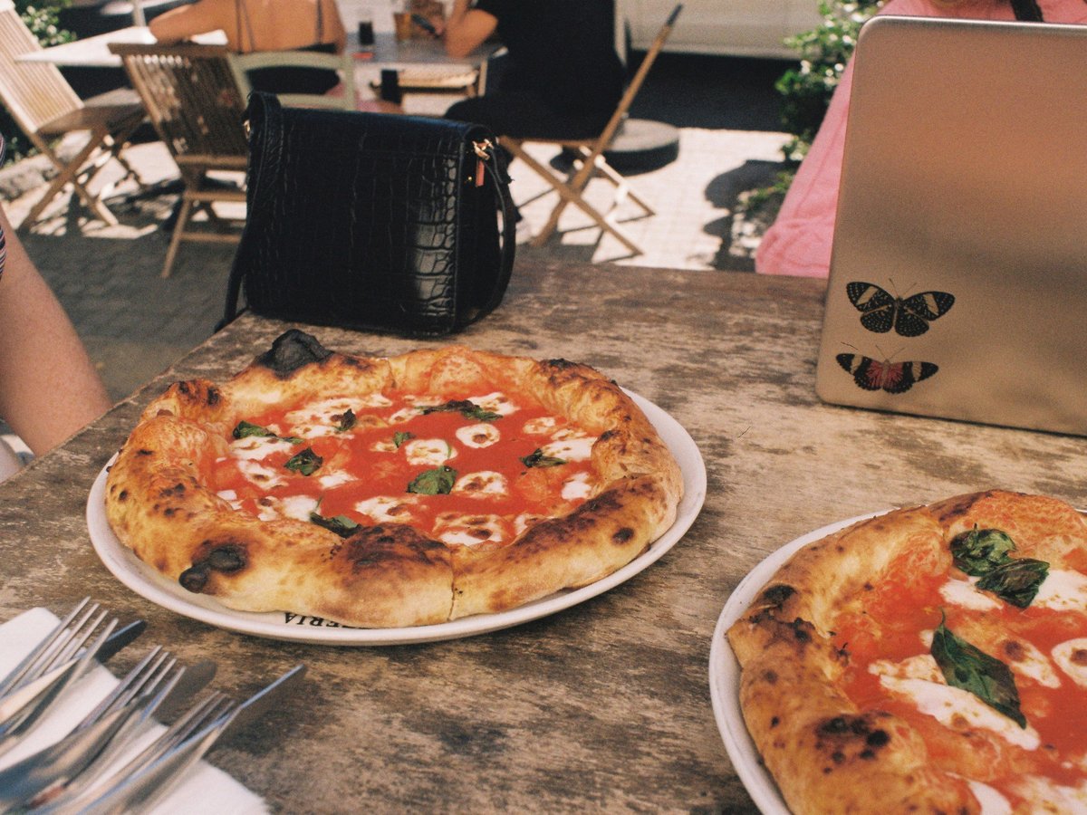 a couple of pizzas sitting on top of a table