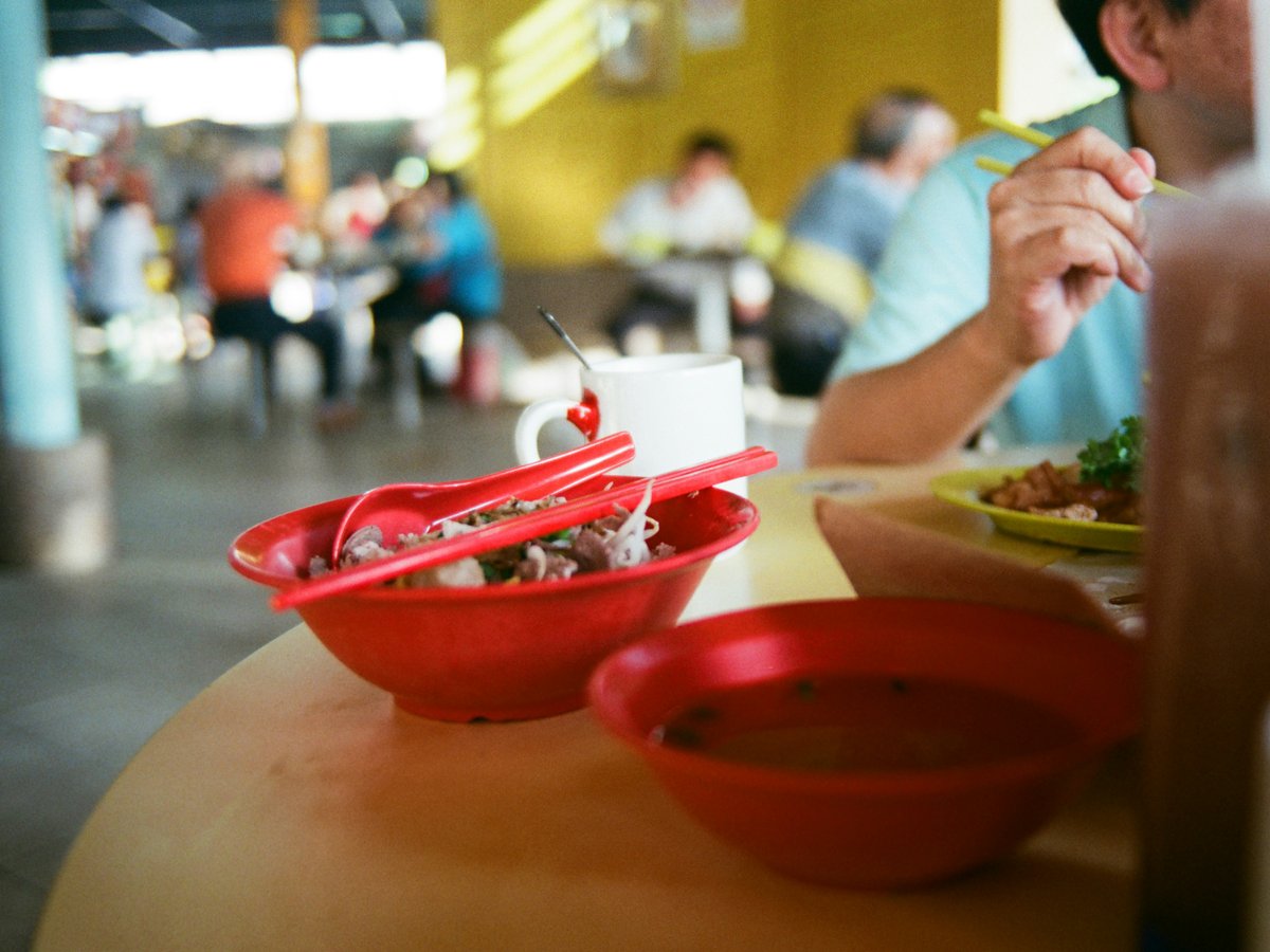 a man sitting at a table with a plate of food