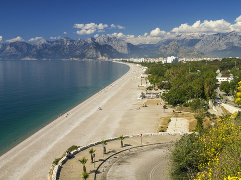 people walking on road near body of water during daytime