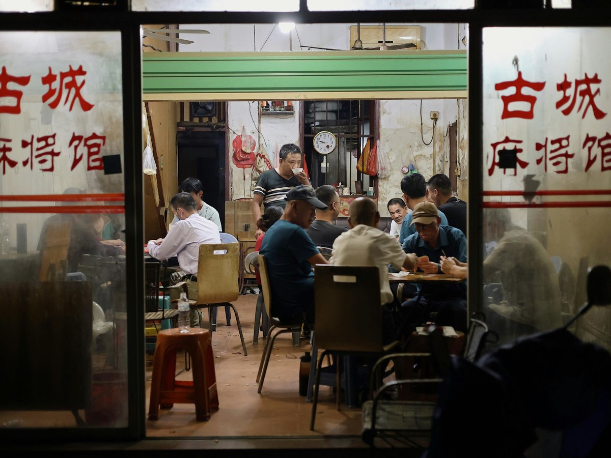A group of people sitting at tables in a restaurant