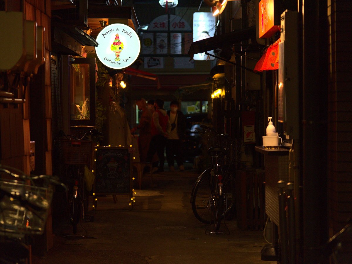 a narrow alley way with a bicycle parked on the side of it