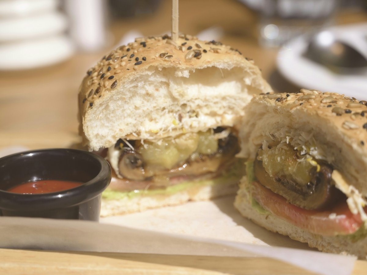 a cut in half sandwich sitting on top of a cutting board