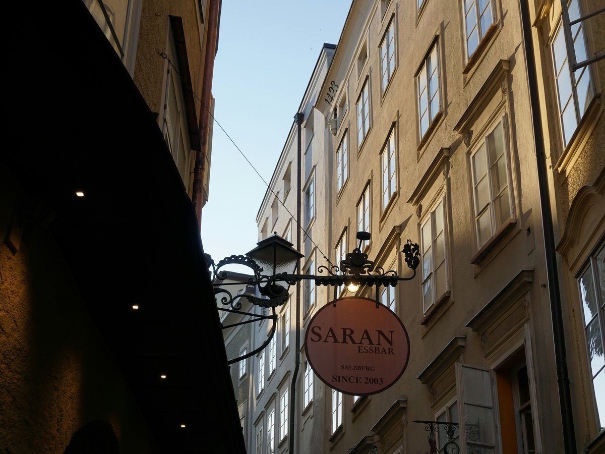 Street lamp with saran sign on old building