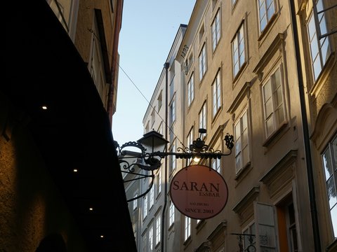 Street lamp with saran sign on old building