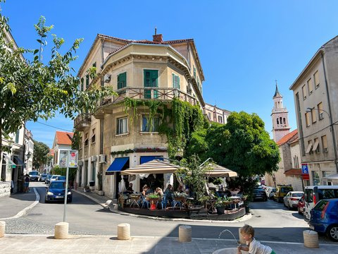 a man sitting on a bench in front of a building