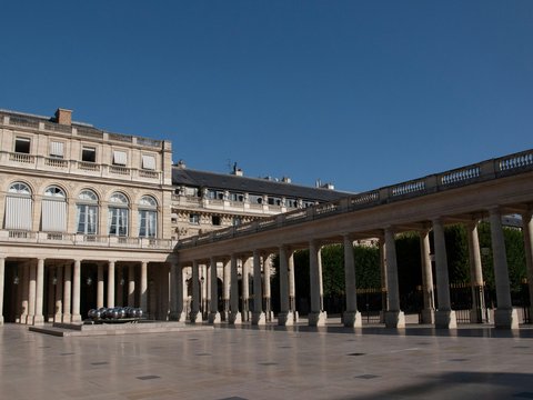 a large building with columns and a car parked in front of it