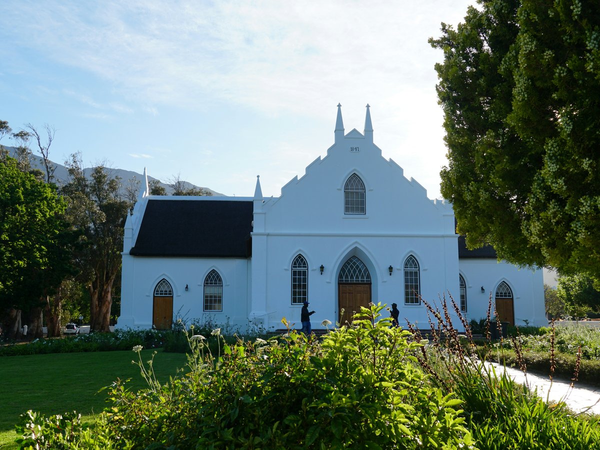 White church nestled amongst lush greenery.