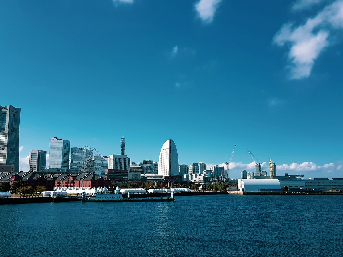 a large body of water with a city in the background