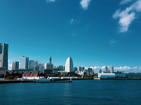 a large body of water with a city in the background