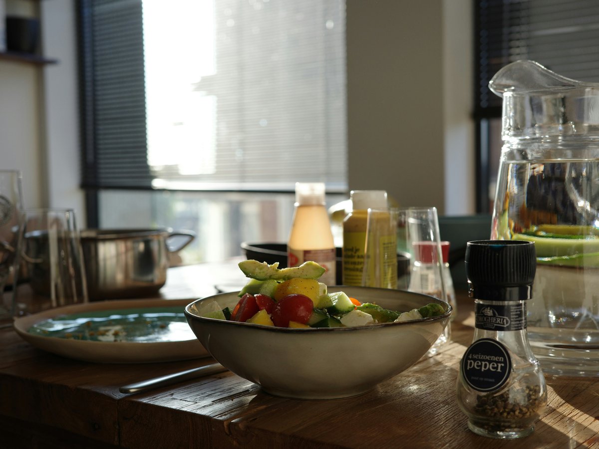 A fresh salad in a bowl on a wooden table.