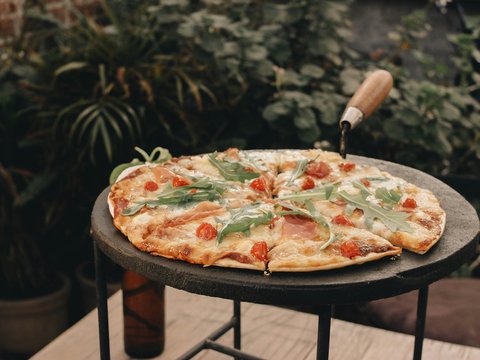 a pizza sitting on top of a black table
