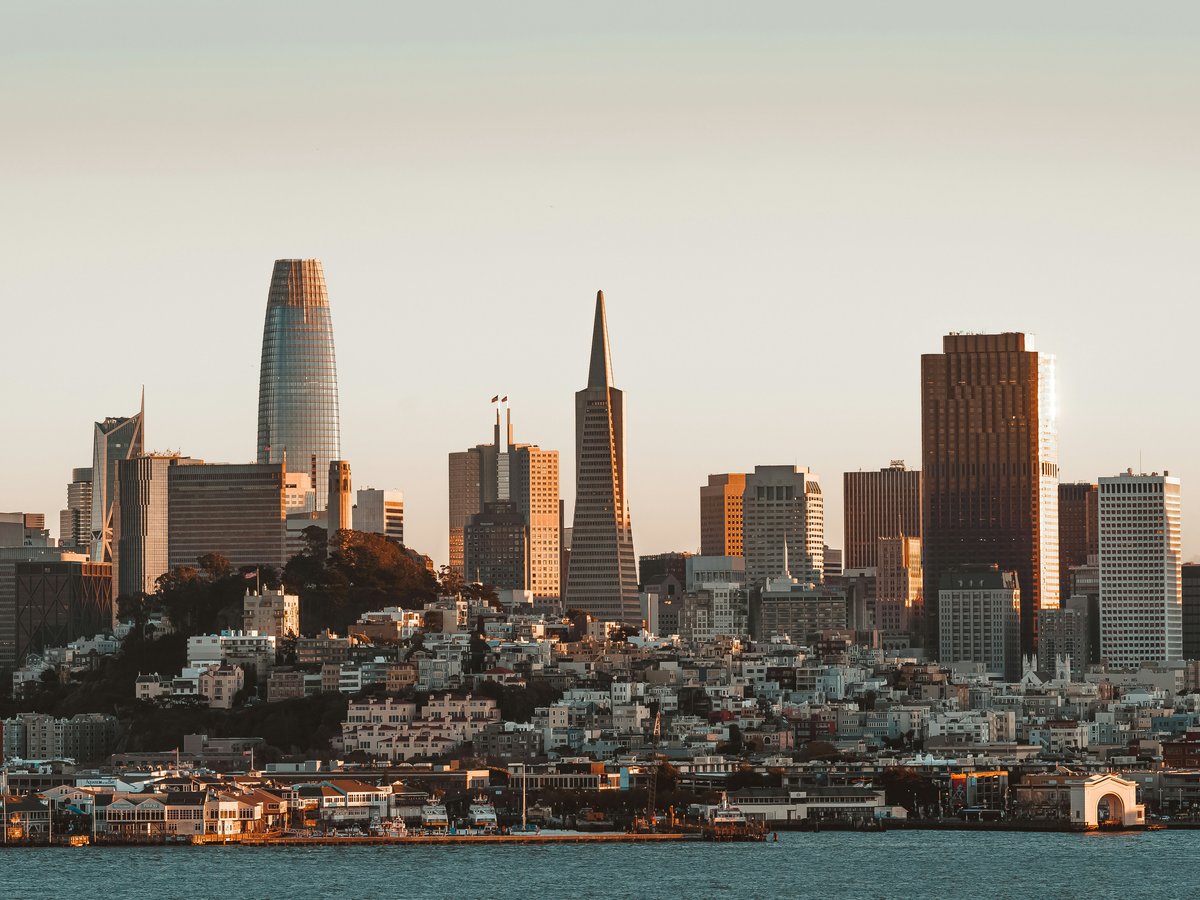 a city skyline with a body of water in the foreground