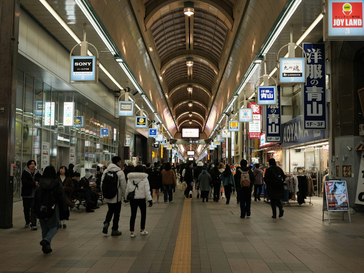 A group of people walking through a train station