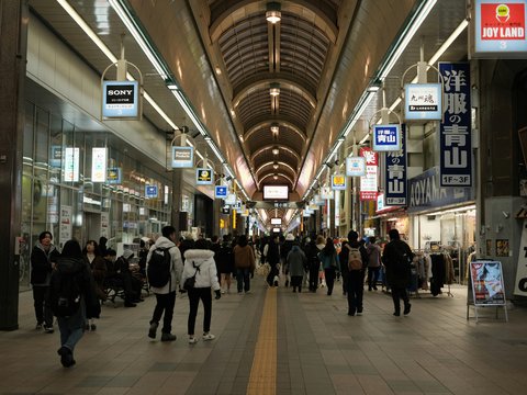 A group of people walking through a train station