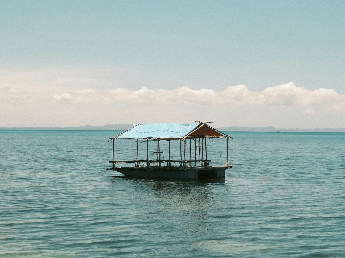 a boat floating on top of a large body of water