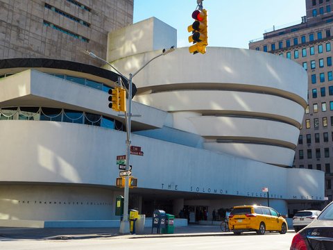 a yellow car is parked in front of a building