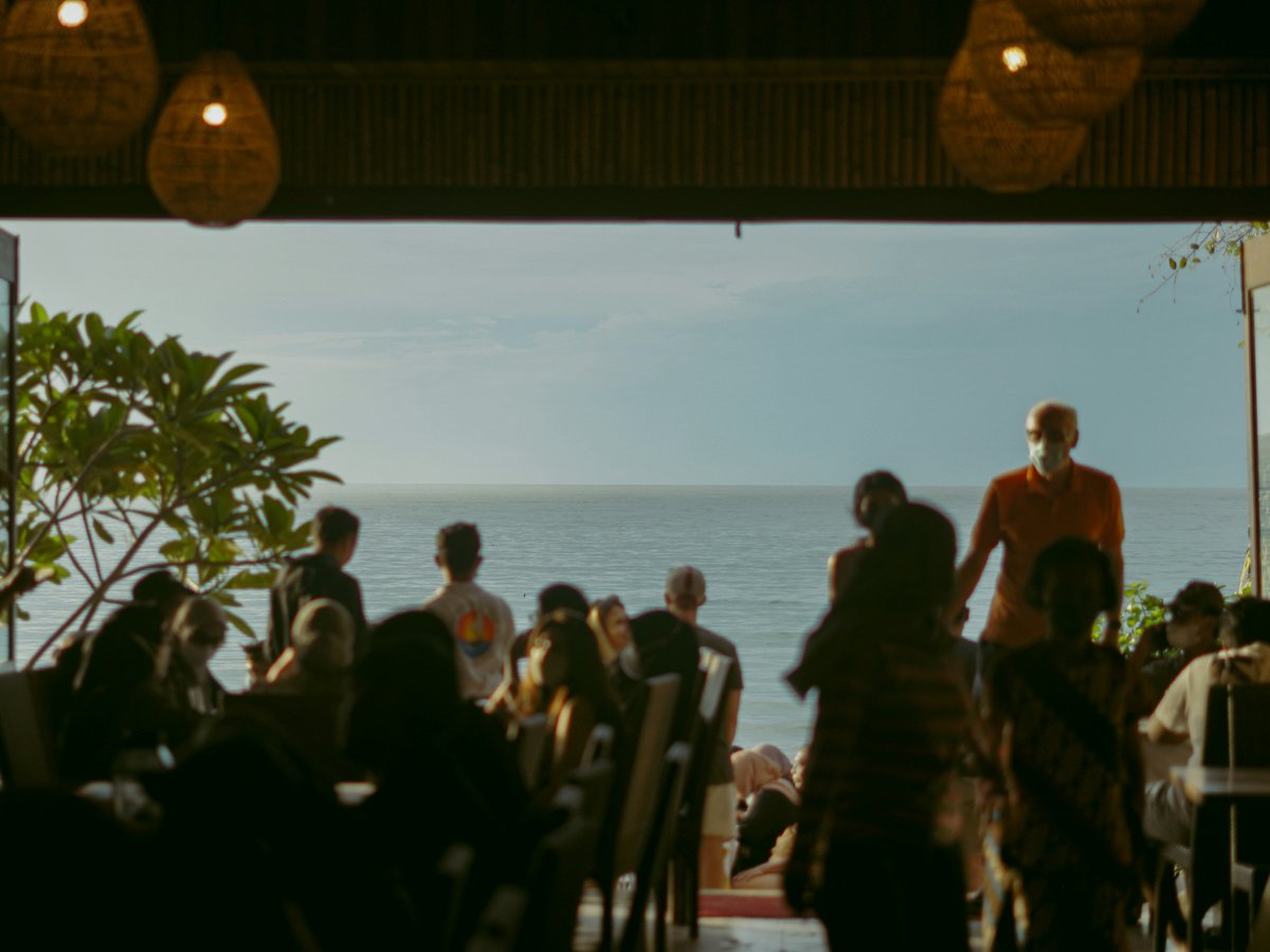 a group of people standing in front of an open door