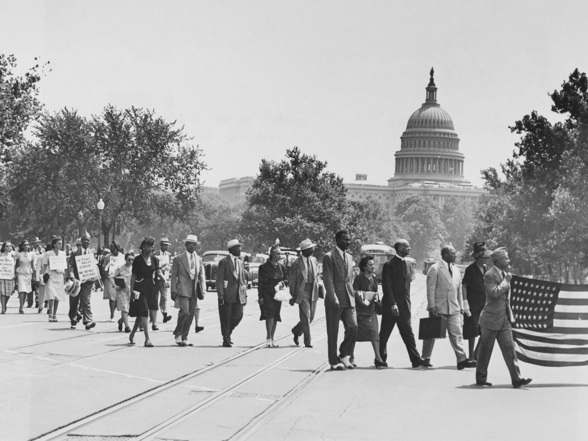 Group of African-Americans, marching near the Capitol building in Washington, D.C., to protest the lynching of four African-Americans in Georgia.