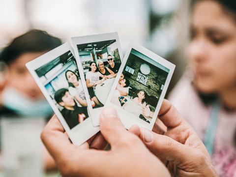person holding 2 women photo