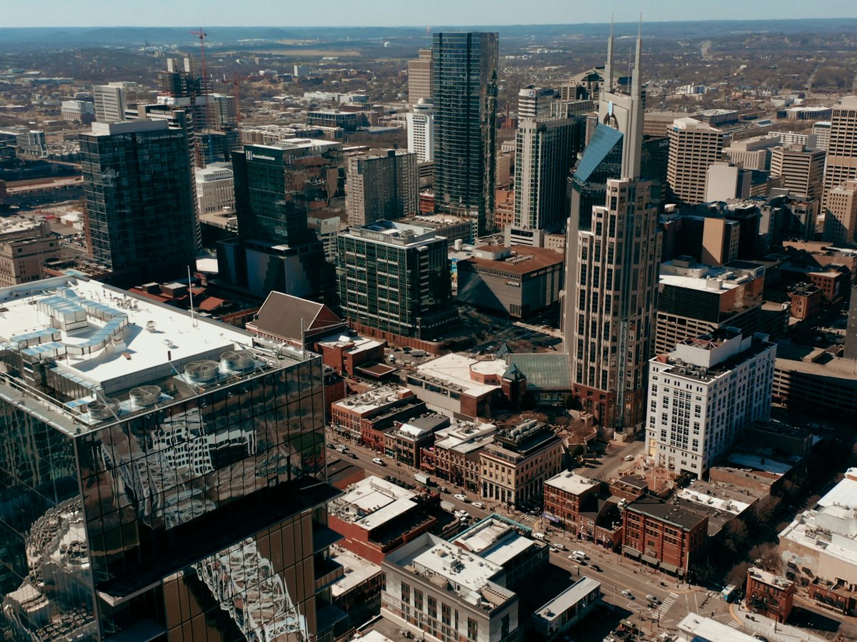 an aerial view of a city with tall buildings