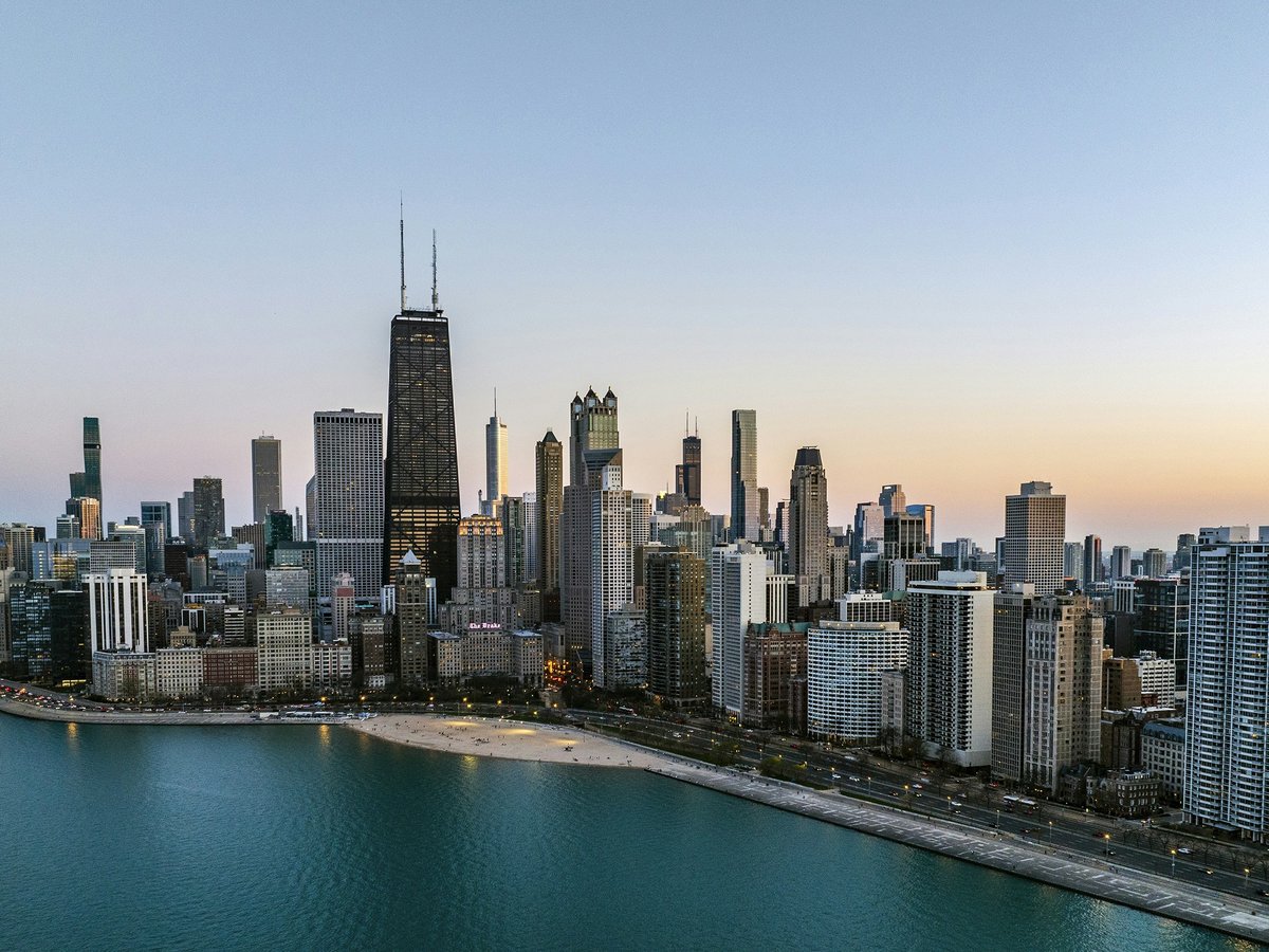 an aerial view of a large city next to a body of water