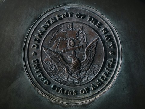 silver round coin on gray textile