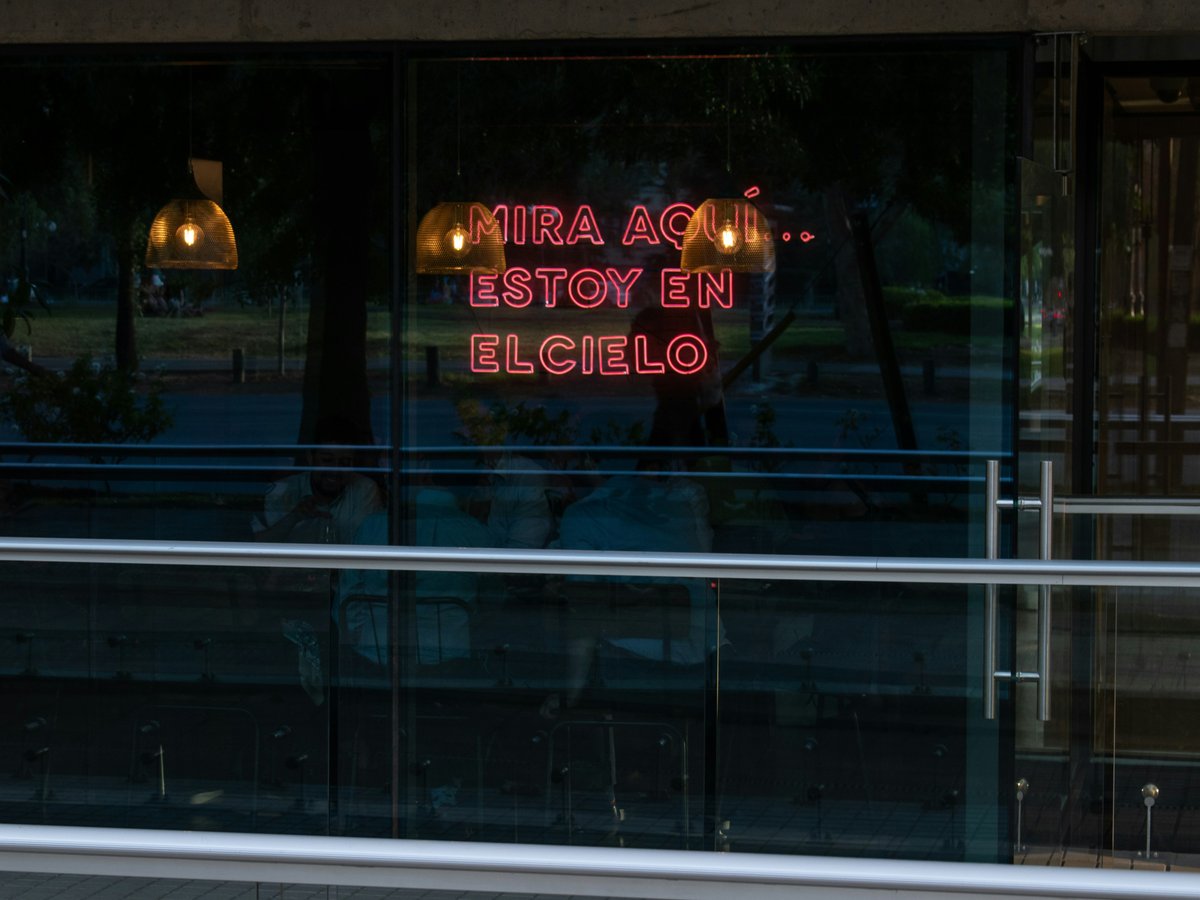 a neon sign in the window of a restaurant