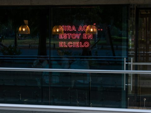 a neon sign in the window of a restaurant