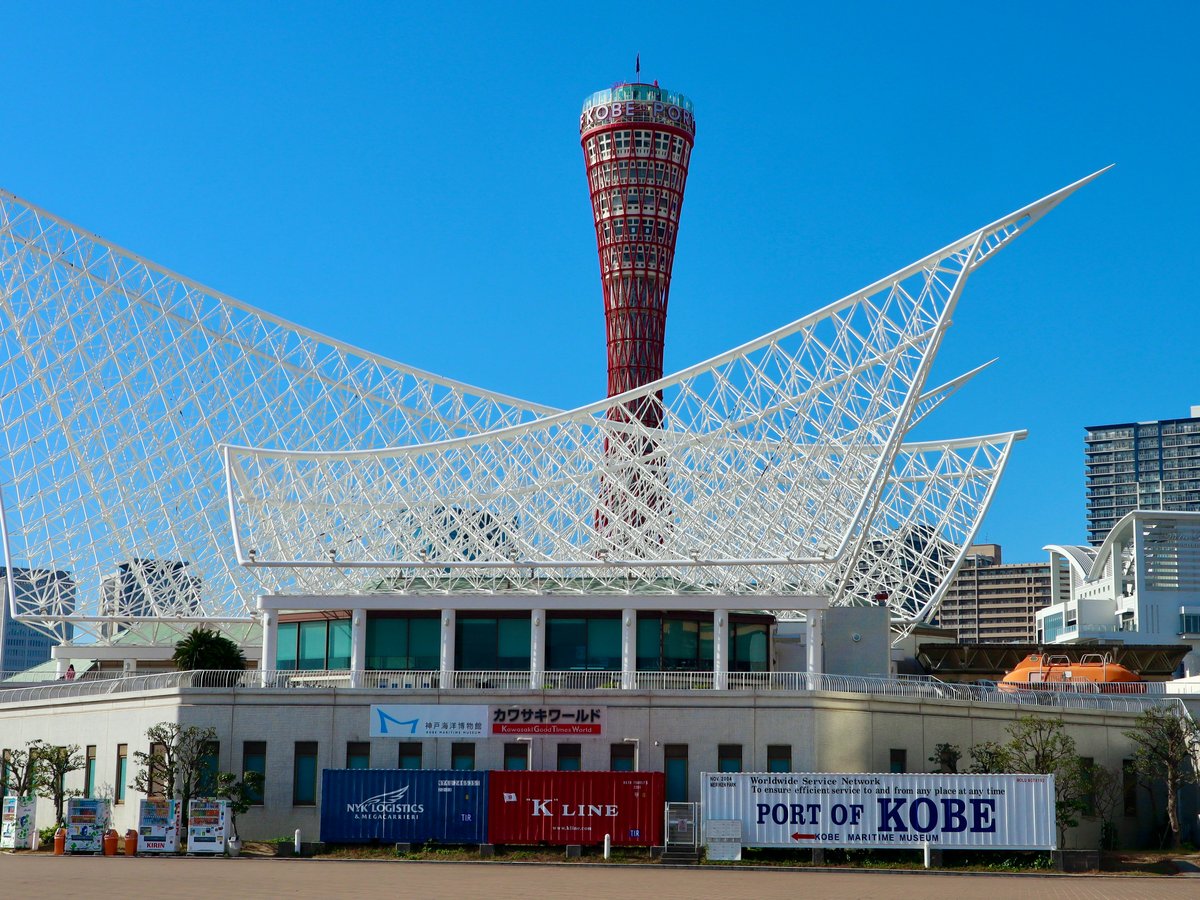 Modern white building with distinctive roof and tower