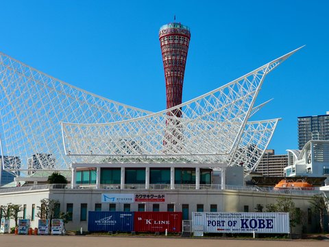 Modern white building with distinctive roof and tower