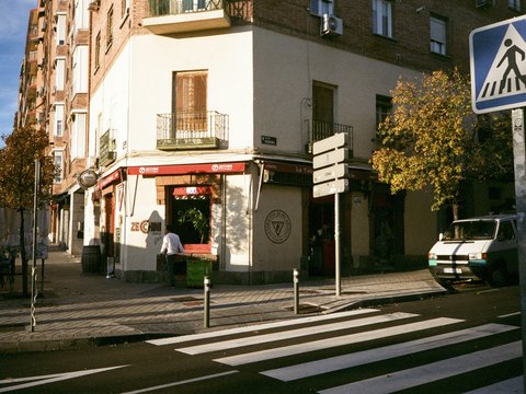 a street corner with a pedestrian crossing sign