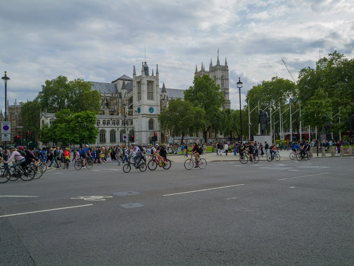 a group of people riding bikes down a street