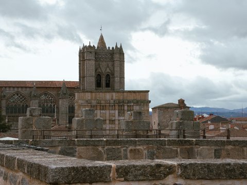 a stone wall with a clock tower in the background