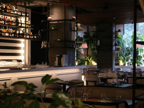 a dimly lit restaurant with tables and chairs