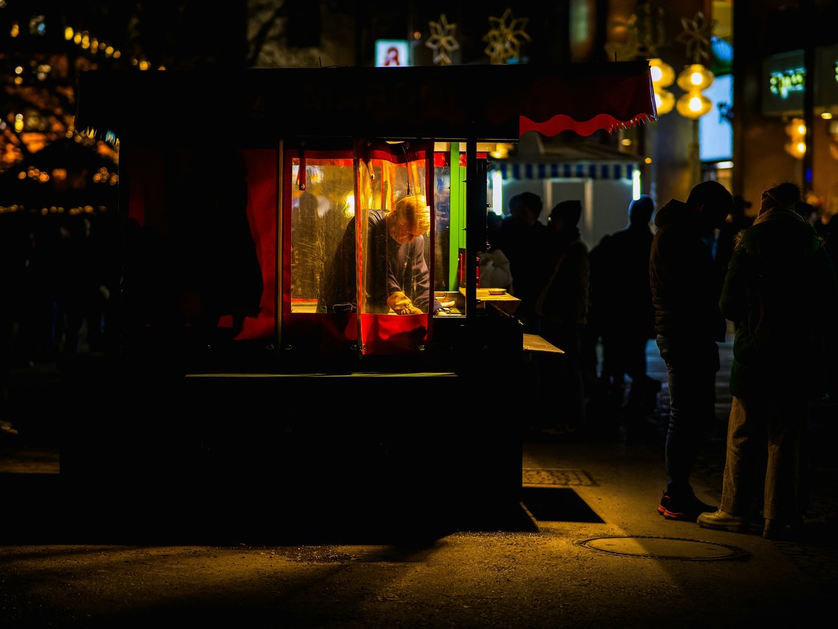 A group of people standing outside of a building at night