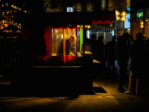 A group of people standing outside of a building at night