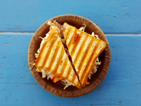 two slices of sandwich on brown container