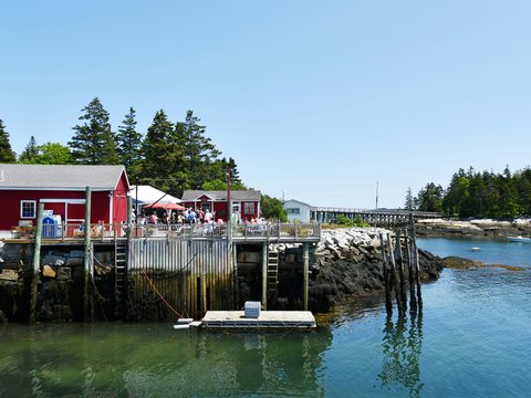 A red building sits on a wooden dock